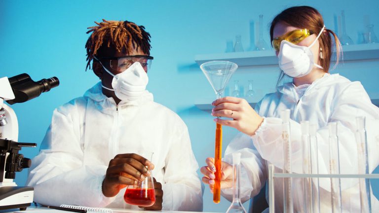 two scientists with different ethnic backgrounds work together in the lab.