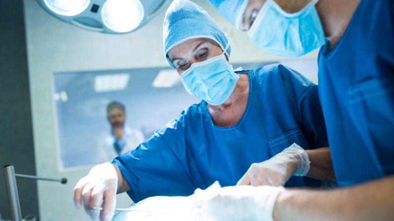 Surgeons performing operation in operation room